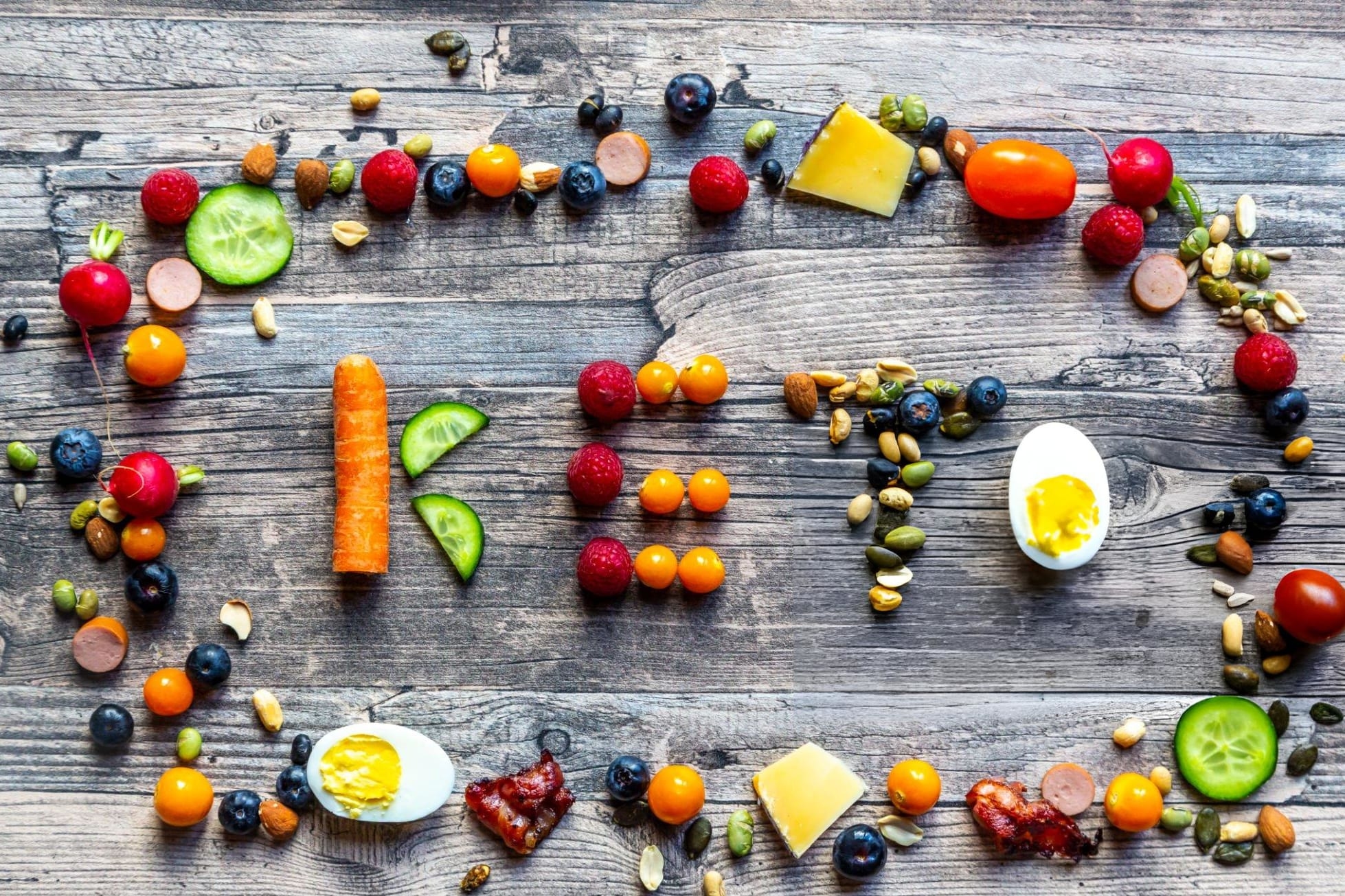 Keto shaped from fruits and vegetables, framed by divers food