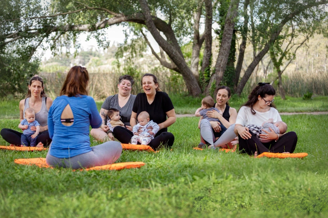  Postpartum Weight Loss - Group of women exercising with their babies in the park - Yoga, stretching and meditation with their babies