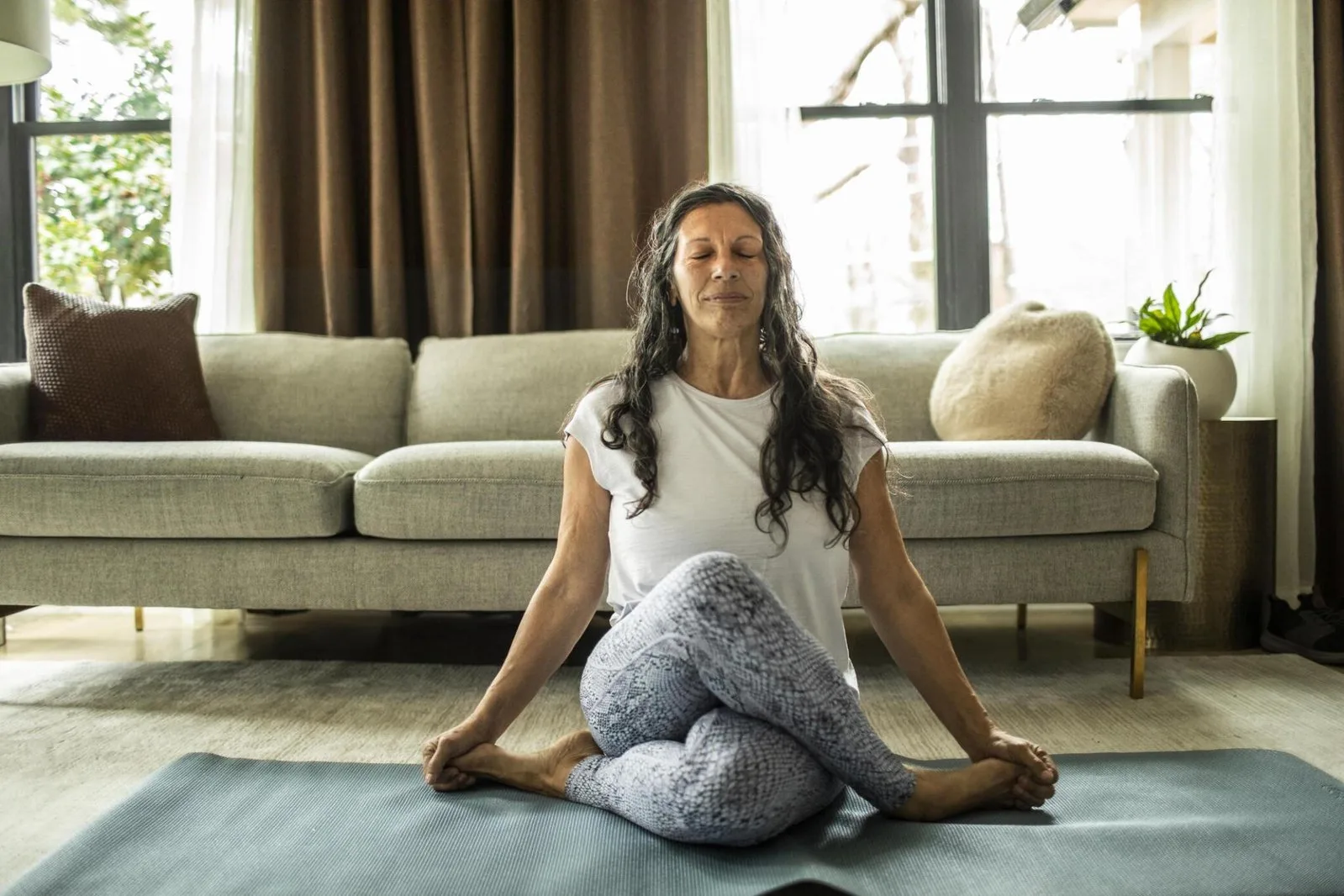 5 Key Exercises to Maintain Strength and Fitness in an Aging Body a women doing yoga