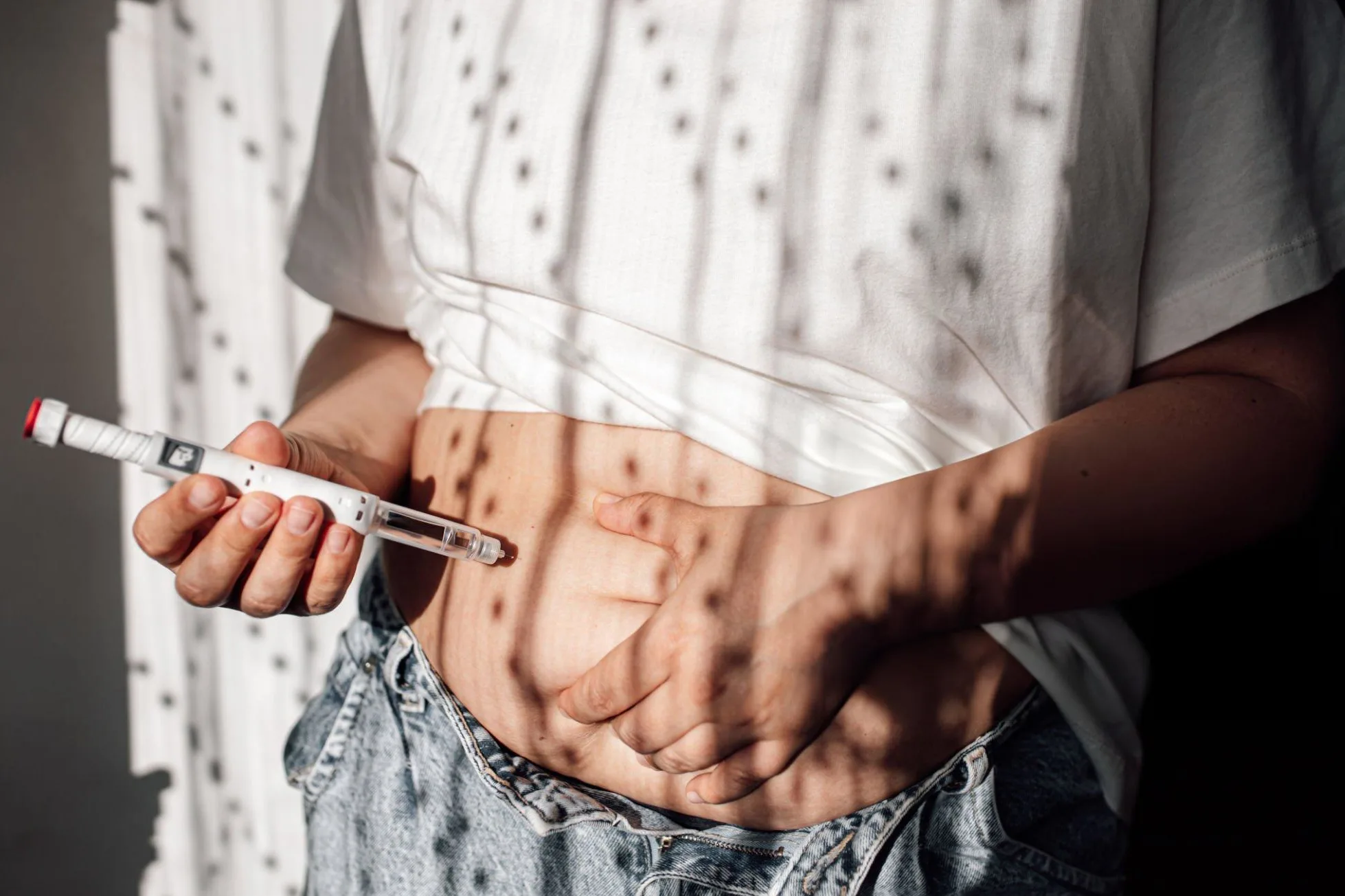 Why BMI Matters for Overweight and Obesity? Injections for weight loss with Semaglutide. An obese woman gives a hormonal injection into the abdomen with a pen syringe